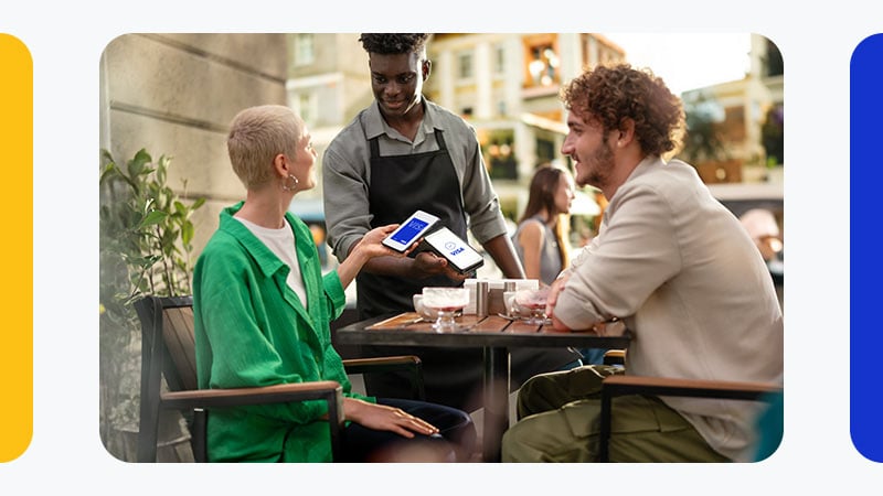 couple paying by phone at restaurant