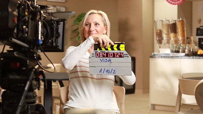 Woman holding clapper board ready for interview