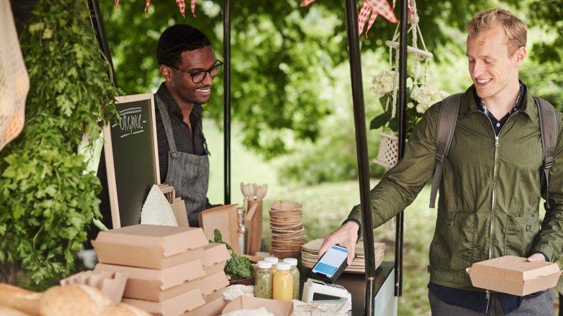 person paying at food stand